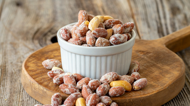 Salted peanuts in a white bowl