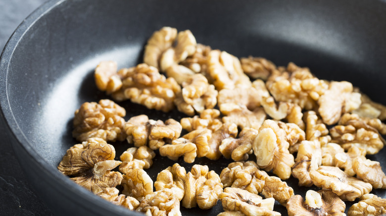 Whole walnuts in a saute pan