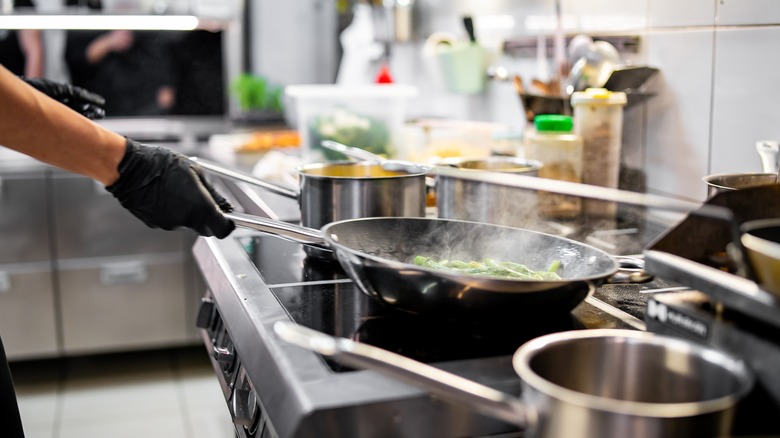 cooking food in steaming stainless steel pan