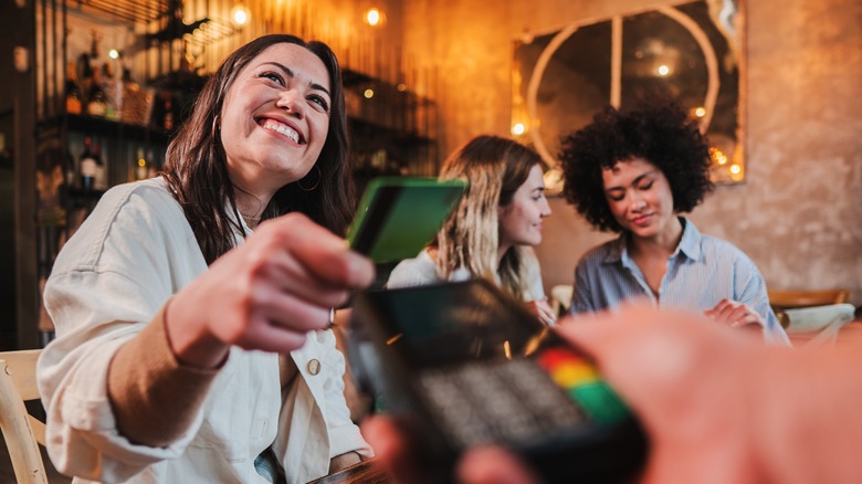 Group paying bill at restaurant