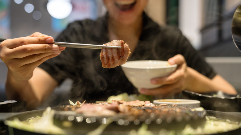 Picking up meat with chopsticks