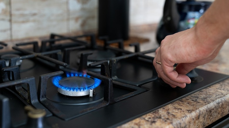 man turning on stove