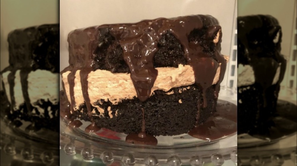 An uneven chocolate cake leaning to one side