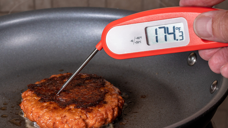 burger meat on stove and thermometer