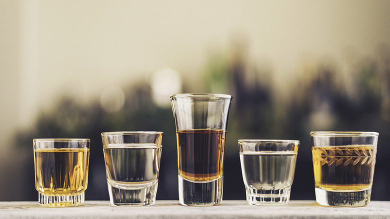 Row of various liquors in shot glasses