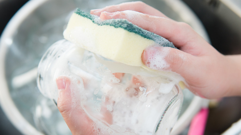 Hands washing glass jar