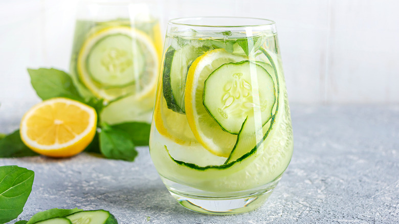 Slices of lemon and cucumber in glass