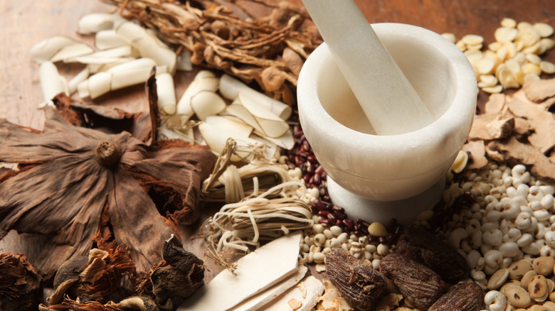 Various whole spices with mortar and pestle