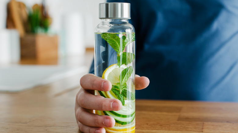 Boy holding infusion water bottle