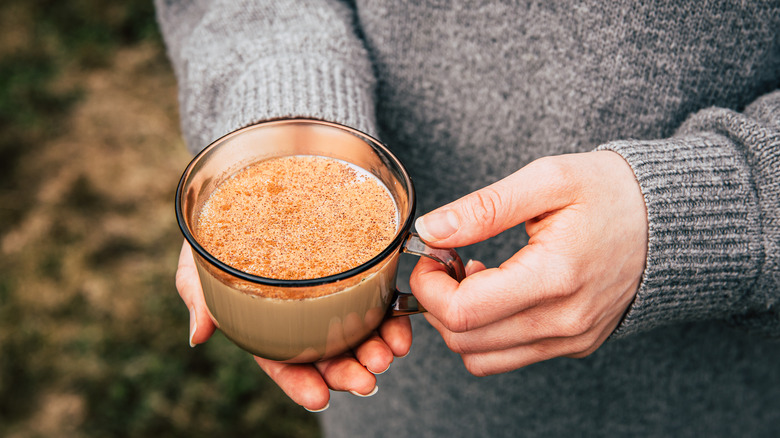 person holding cup of chai