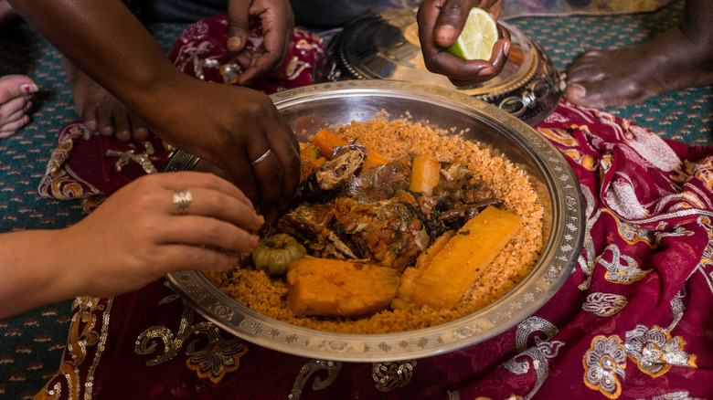 eating couscous with hands