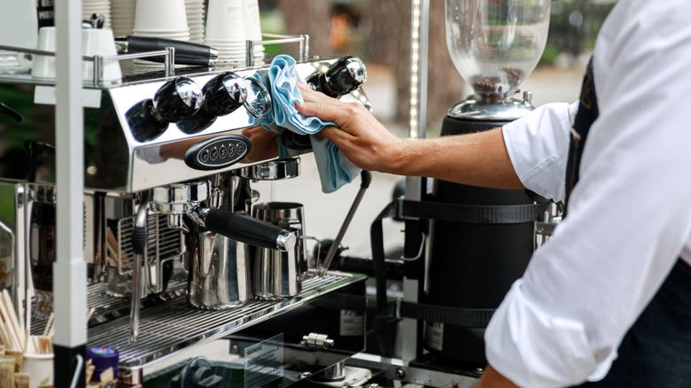 Man cleaning an espresso machine