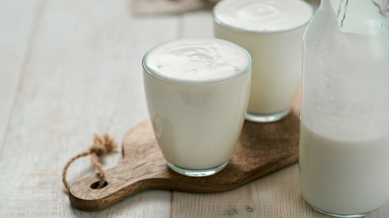 Buttermilk in two glasses on wooden board