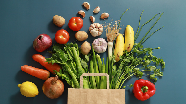 paper bag spilling out vegetables 