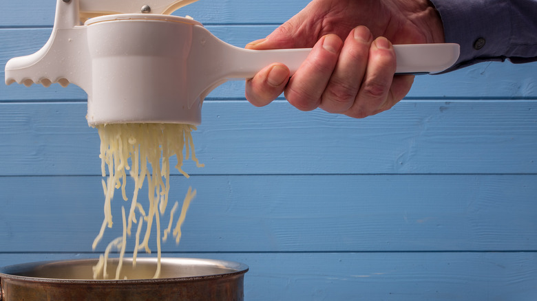 person using a potato ricer