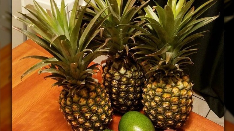 Assortment of pineapples and mangos