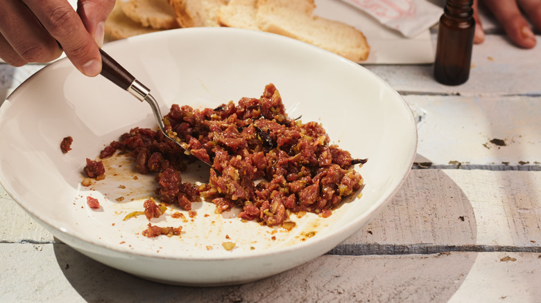 mixing steak tartare in dish