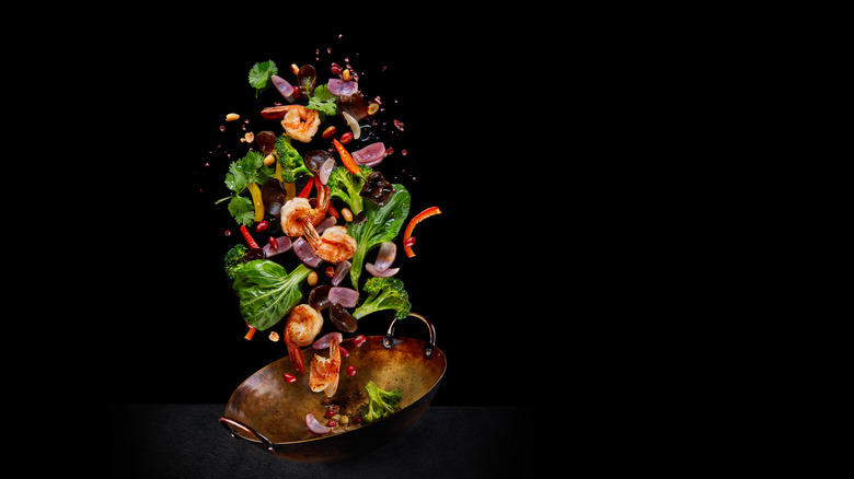 Abstract shot of food being tossed in a wok