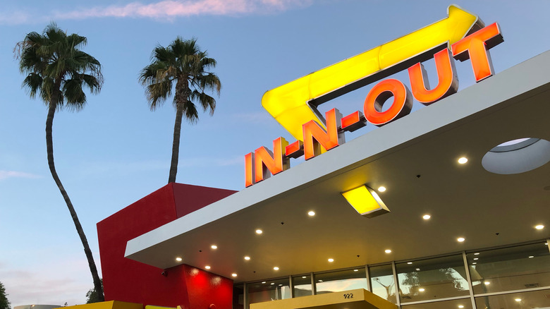 In-n-Out Burger sign with palm trees in background