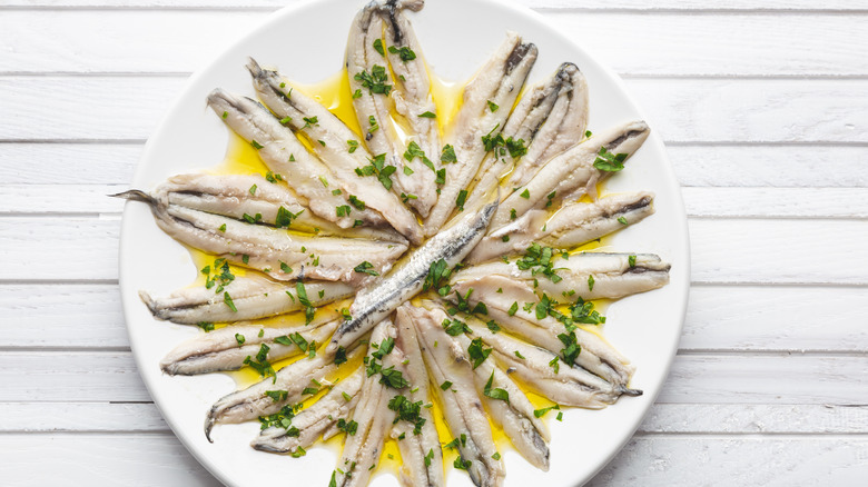 marinated anchovies on white plate