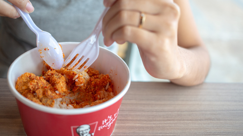 person eating custom KFC bowl