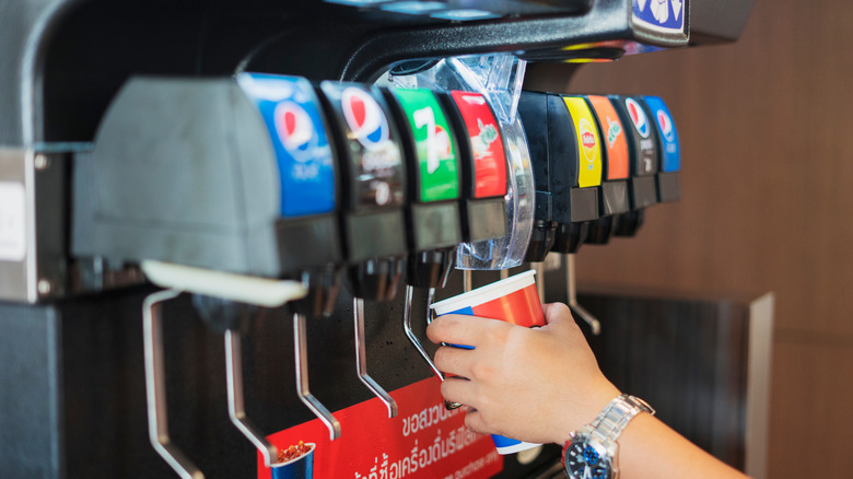 person getting ice from dispenser