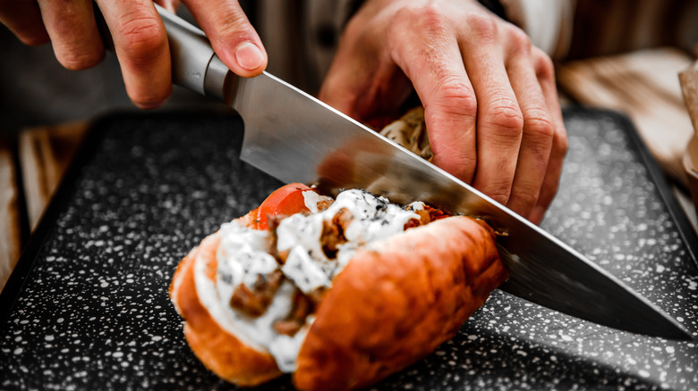 slicing a sub with knife