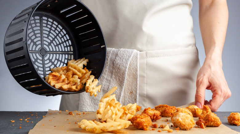 Emptying fried foods from a frying basket