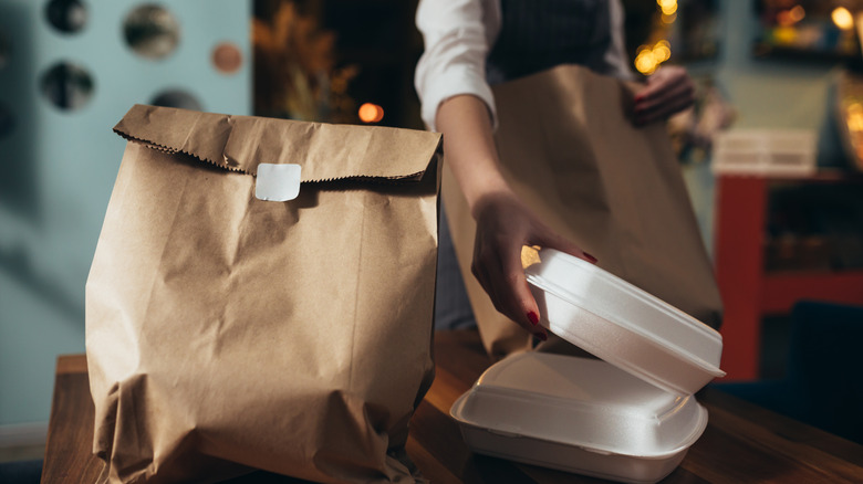 Server preparing takeout boxes