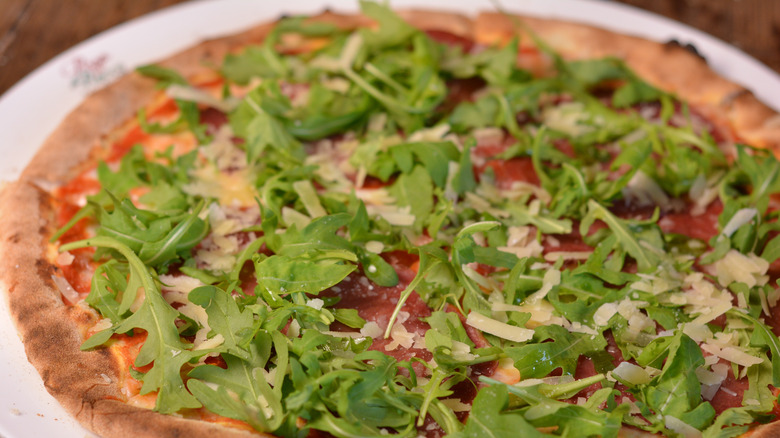 pizza with fresh greens on top