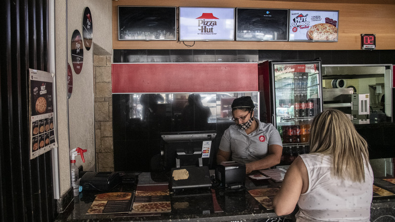 employee waiting on customer at Pizza Hut