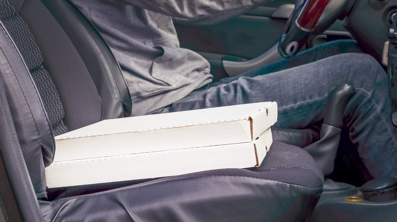 pizza boxes on a car seat