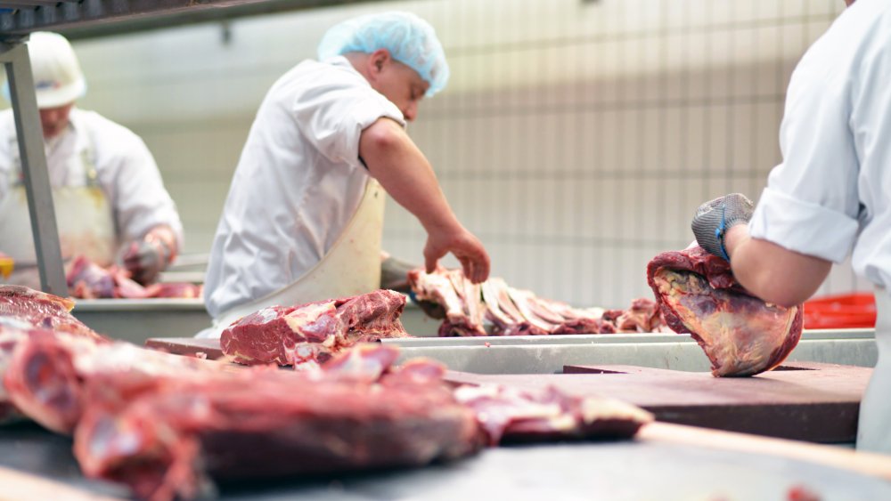 Butchers cutting steak