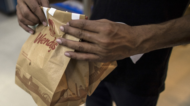 Employee holding Wendy's orders