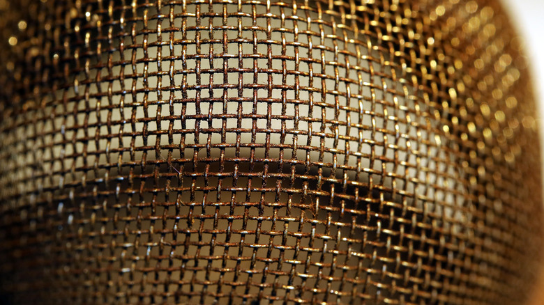 Close up of dirty mesh strainer