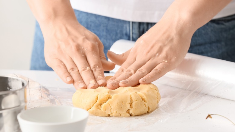 Person kneading pastry dough