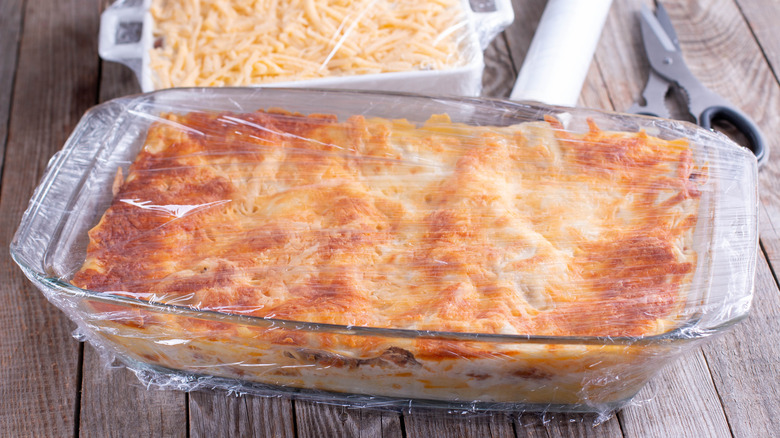 frozen wrapped lasagna on table