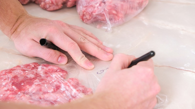 person labeling bag of meat