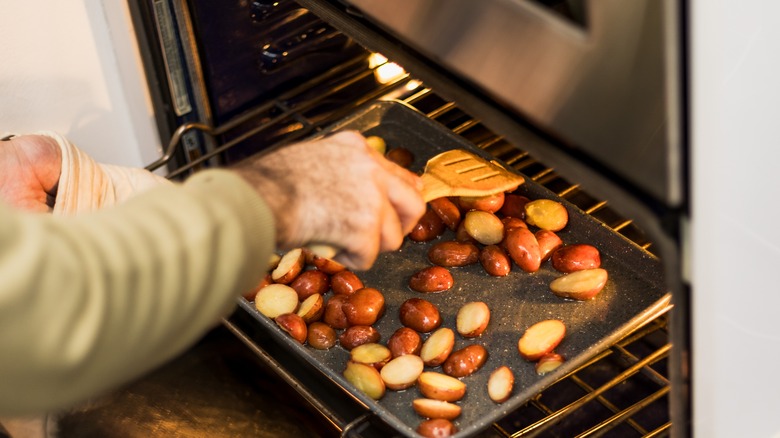 flipping potatoes in oven pan