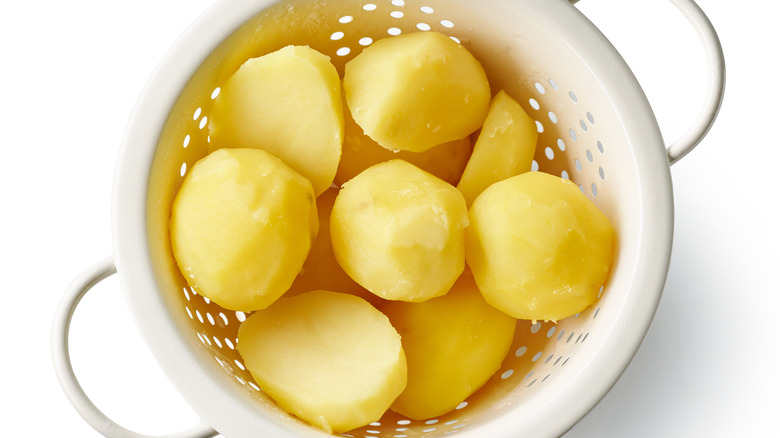 cooked potatoes drying in colander