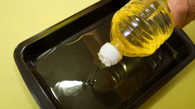 oil being poured into baking dish