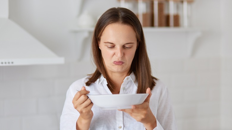 Woman making disgusted face