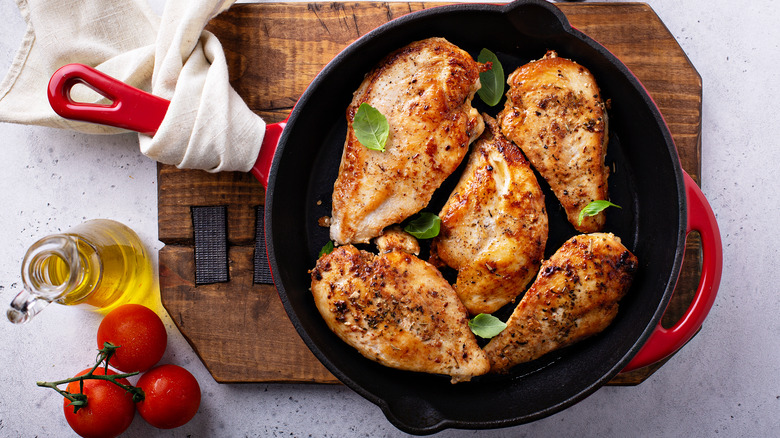 chicken breasts crowded in skillet 