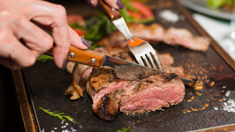 cutting into steak