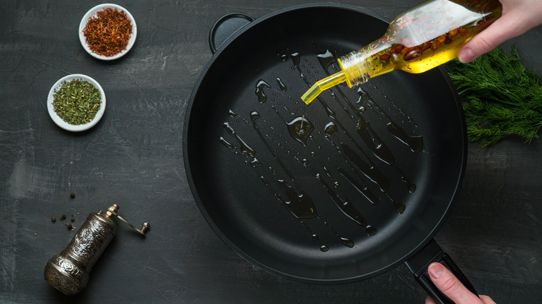 pouring oil into pan