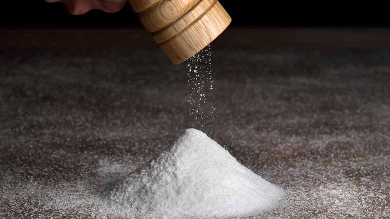 salt grinder over pile of salt