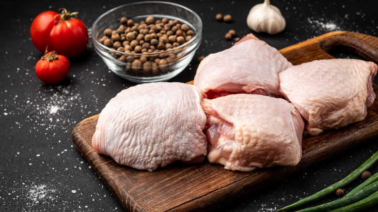 raw chicken thighs on cutting board