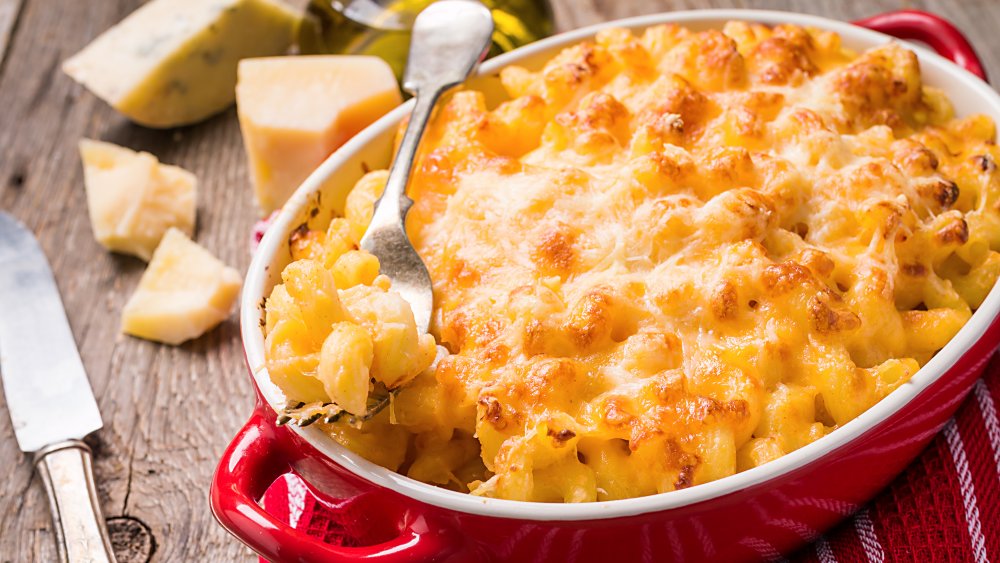 Photo of a serving dish of mac and cheese on a table