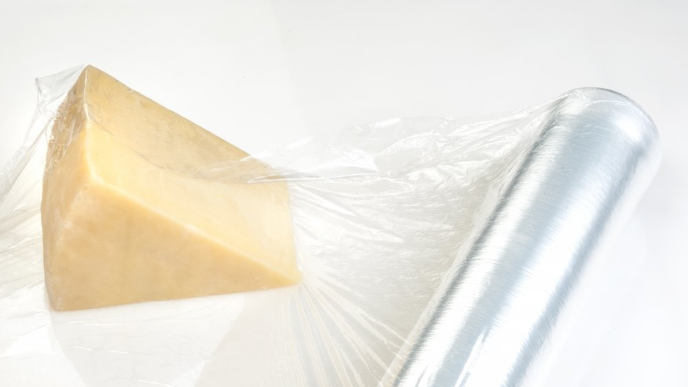 Piece of cheese wrapped in plastic wrap