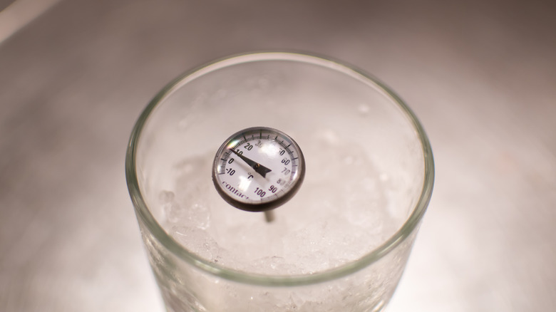 Meat thermometer in a glass of ice water